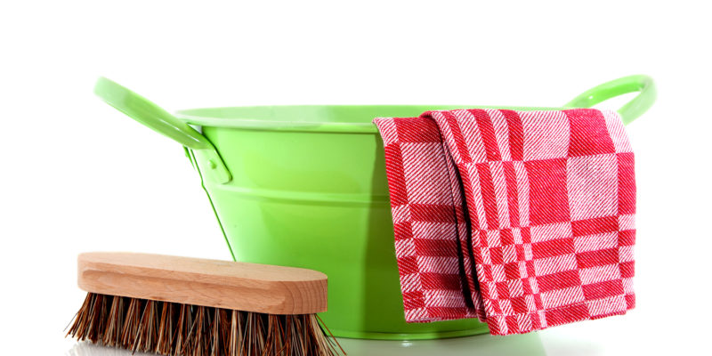 Green metal bucket with cleaning brush